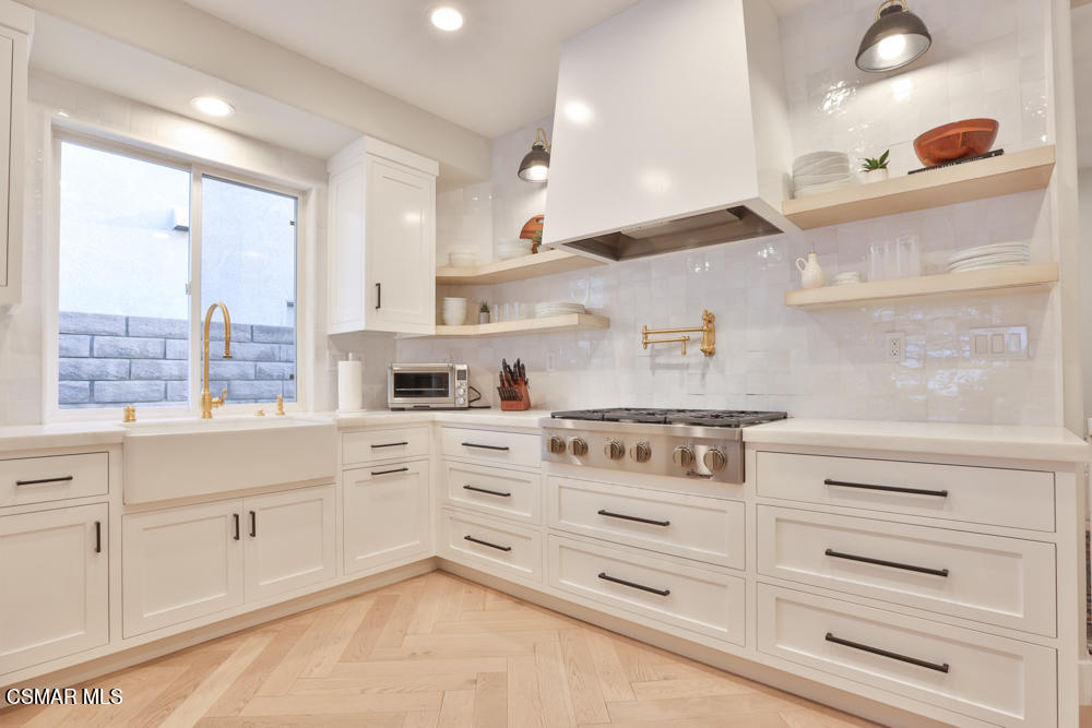 4630 Rio Bravo Court Moorpark, CA 93021 - Photo 29 of 58 a kitchen with granite countertop white cabinets and white appliances