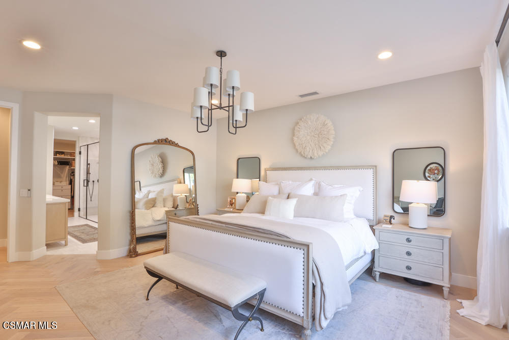 4630 Rio Bravo Court Moorpark, CA 93021 - Photo 34 of 58 a bedroom with bed and a chandelier