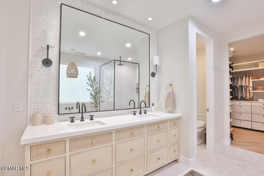 4630 Rio Bravo Court Moorpark, CA 93021 - Photo 39 of 58 a bathroom with a double vanity sink mirror and double
