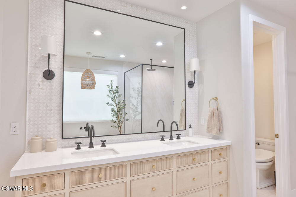 4630 Rio Bravo Court Moorpark, CA 93021 - Photo 40 of 58 a bathroom with a double vanity sink and a mirror