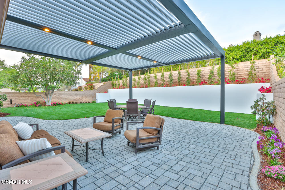 4630 Rio Bravo Court Moorpark, CA 93021 - Photo 49 of 58 a patio with table and chairs and potted plants