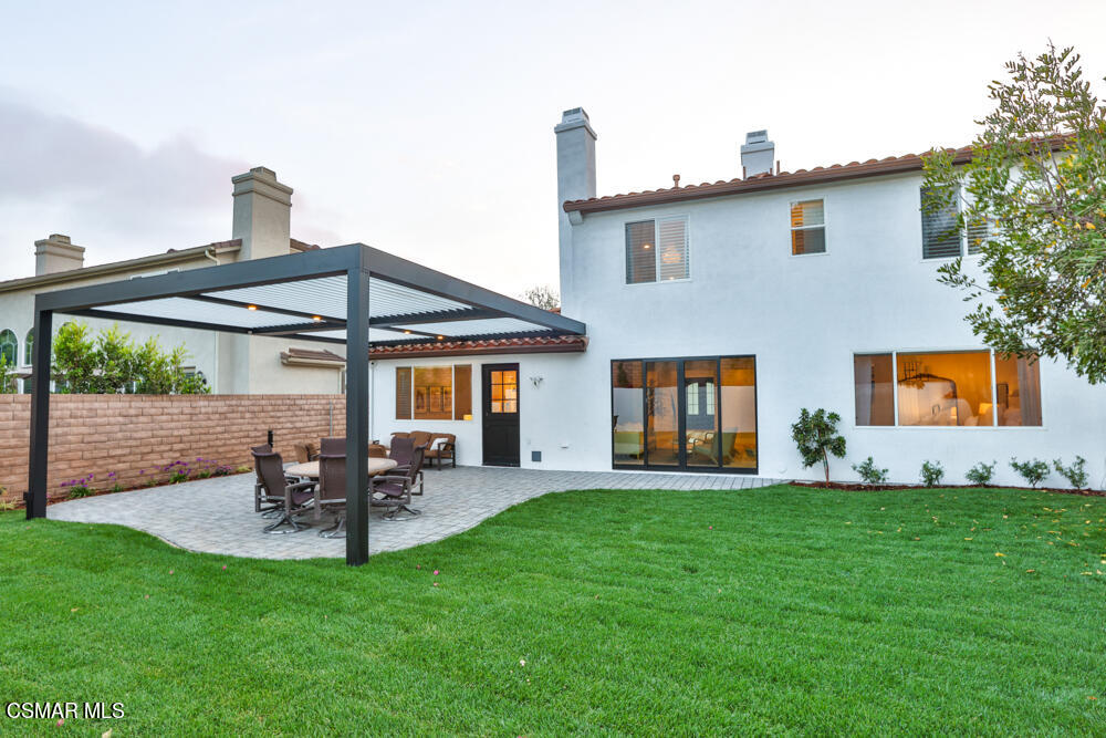 4630 Rio Bravo Court Moorpark, CA 93021 - Photo 52 of 58 a patio with a table and chairs under an umbrella