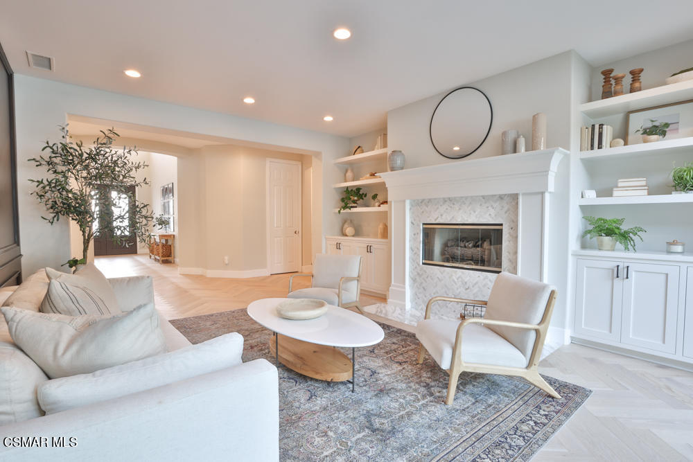 4630 Rio Bravo Court Moorpark, CA 93021 - Photo 9 of 58 a living room with furniture a fireplace and a potted plant
