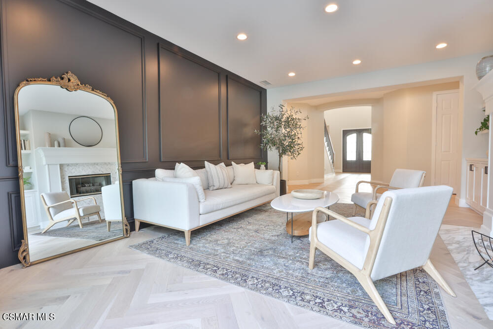 4630 Rio Bravo Court Moorpark, CA 93021 - Photo 10 of 58 a living room with furniture a fireplace and a large mirror