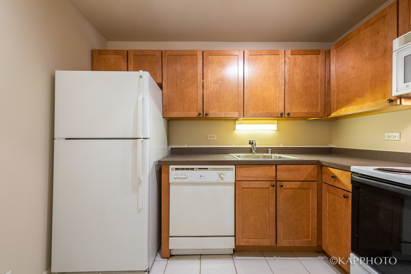 655 West Irving Park Road, Unit 1505 Chicago, IL 60613 - Photo 11 of 26 a kitchen with a refrigerator sink and cabinets