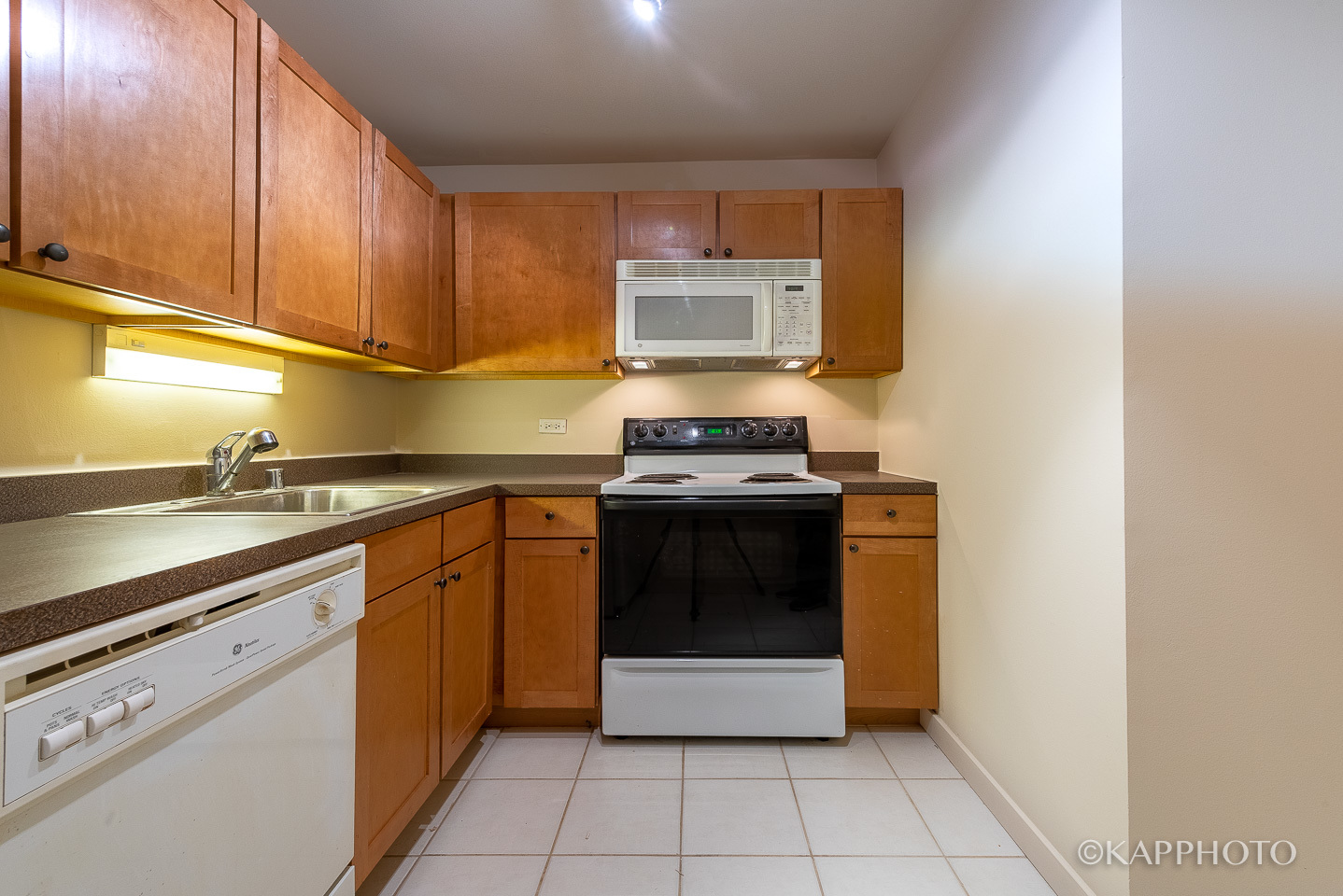 655 West Irving Park Road, Unit 1505 Chicago, IL 60613 - Photo 12 of 26 a kitchen with stainless steel appliances granite countertop a stove a sink and a microwave