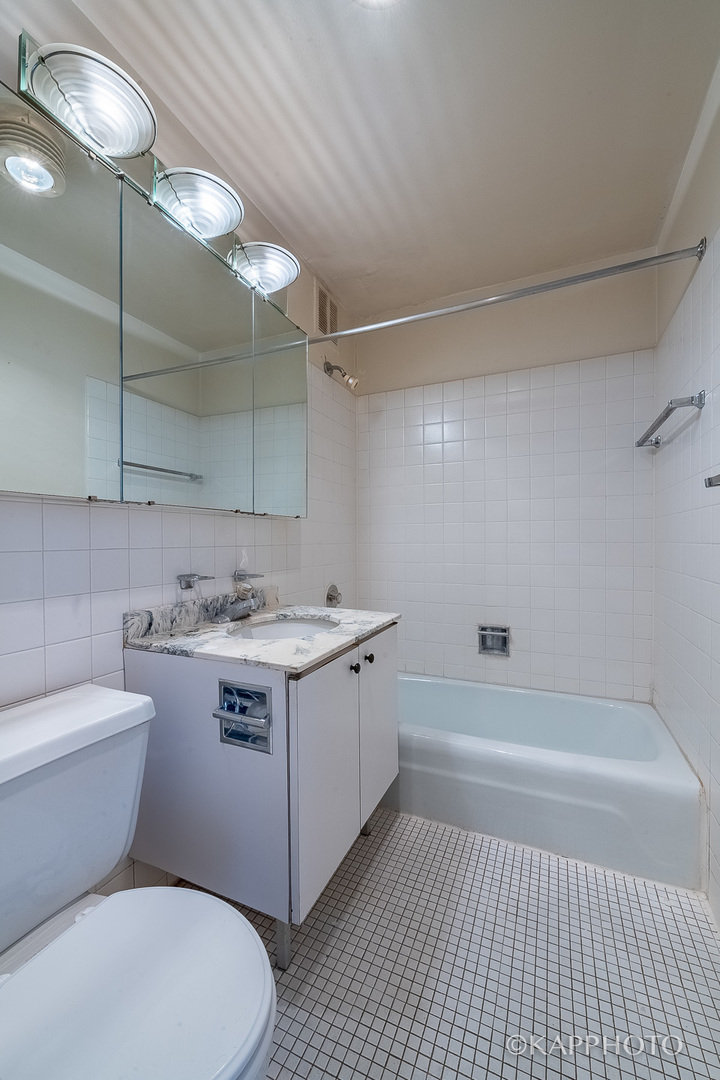 655 West Irving Park Road, Unit 1505 Chicago, IL 60613 - Photo 19 of 26 a bathroom with a sink a toilet and shower