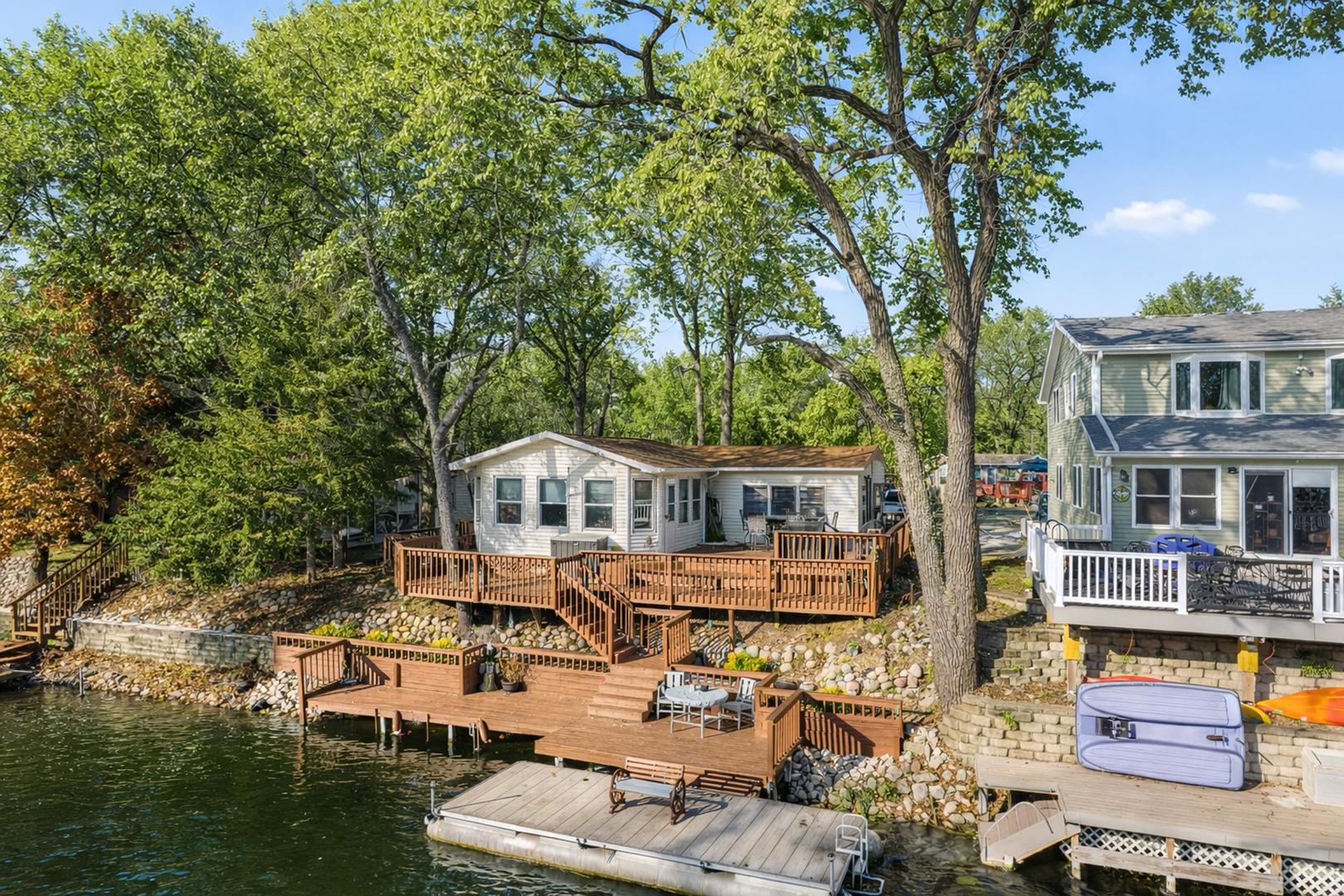 an aerial view of a house with swimming pool and furniture