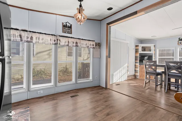 a view of an entryway with wooden floor