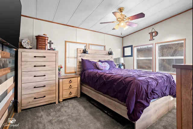 a spacious bedroom with a bed and a chandelier
