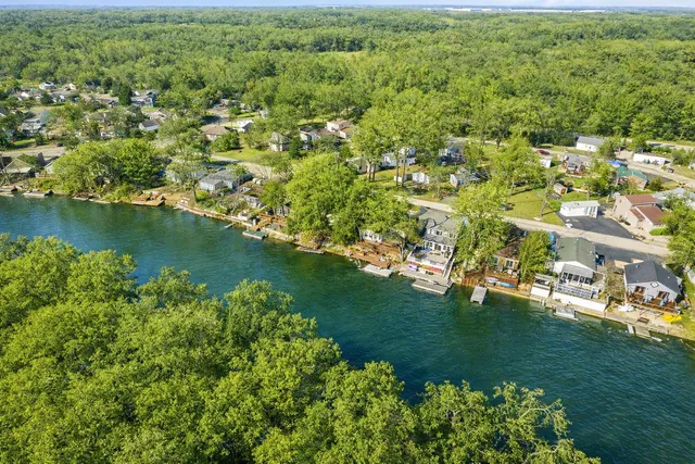 an aerial view of a house with swimming pool and furniture
