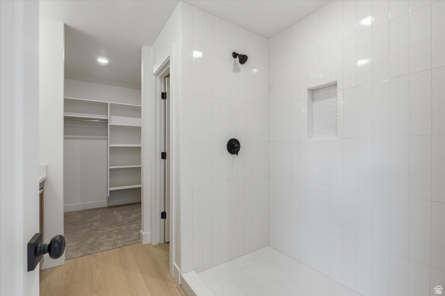 844 North 400 West Logan, UT 84321 - Photo 22 of 43 Walk-in shower with vertical subway tile, integrated niche, and matte black fixtures