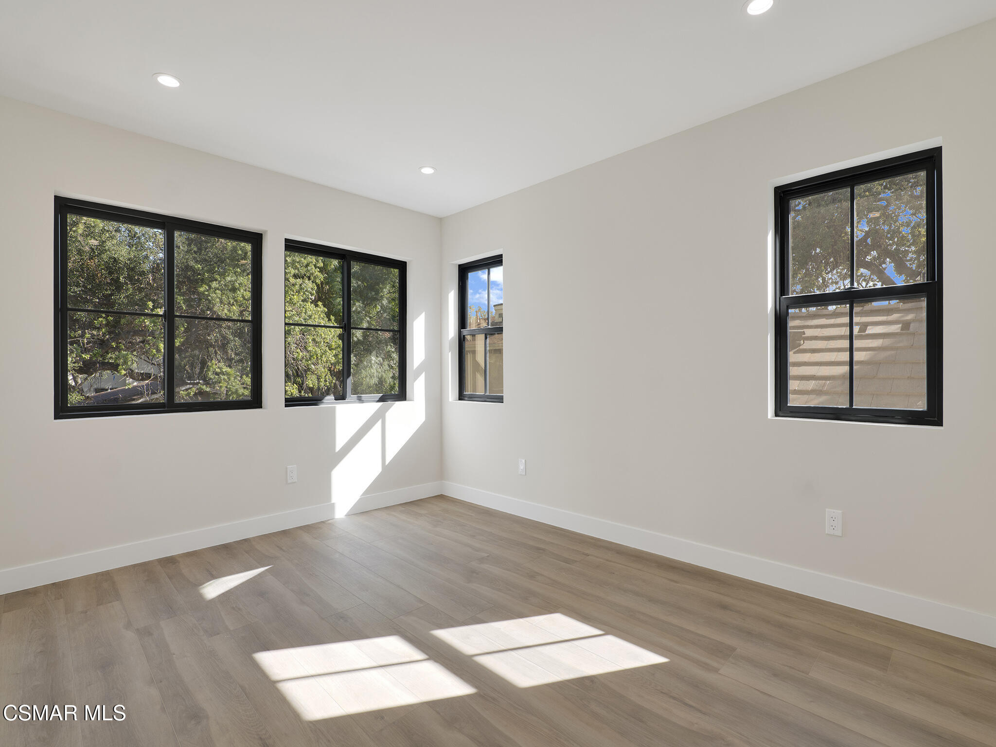 3190 Los Robles Road, Unit C Thousand Oaks, CA 91362 - Photo 11 of 14 a view of an empty room with wooden floor and windows