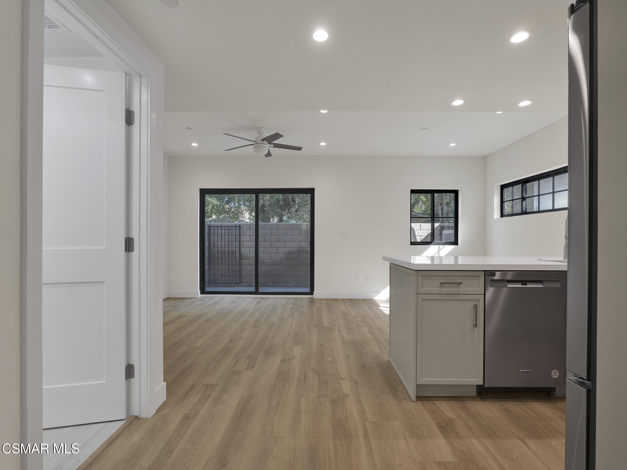 3190 Los Robles Road, Unit C Thousand Oaks, CA 91362 - Photo 2 of 14 a hall with kitchen island granite countertop cabinets and wooden floor