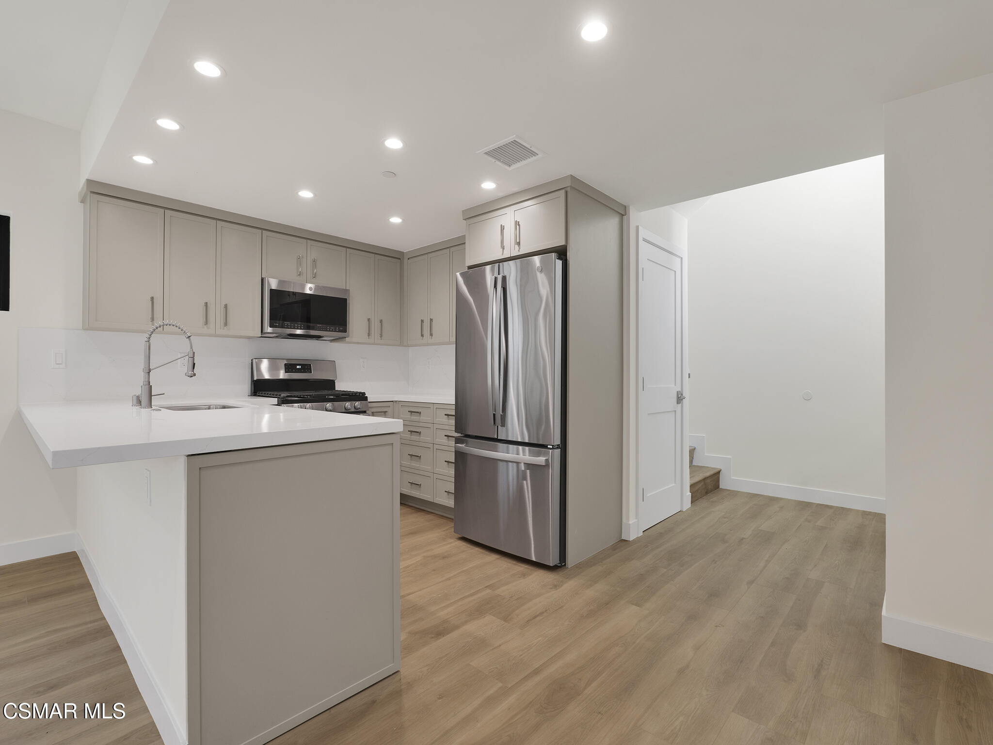 3190 Los Robles Road, Unit C Thousand Oaks, CA 91362 - Photo 8 of 14 a kitchen with kitchen island a sink stainless steel appliances and refrigerator