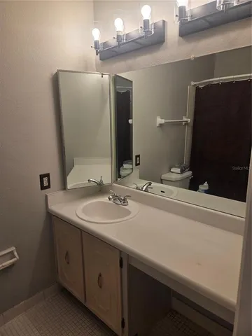 a bathroom with a double vanity sink and mirror
