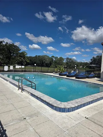 a view of a swimming pool with a yard