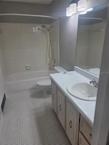 a bathroom with a double vanity sink toilet and shower