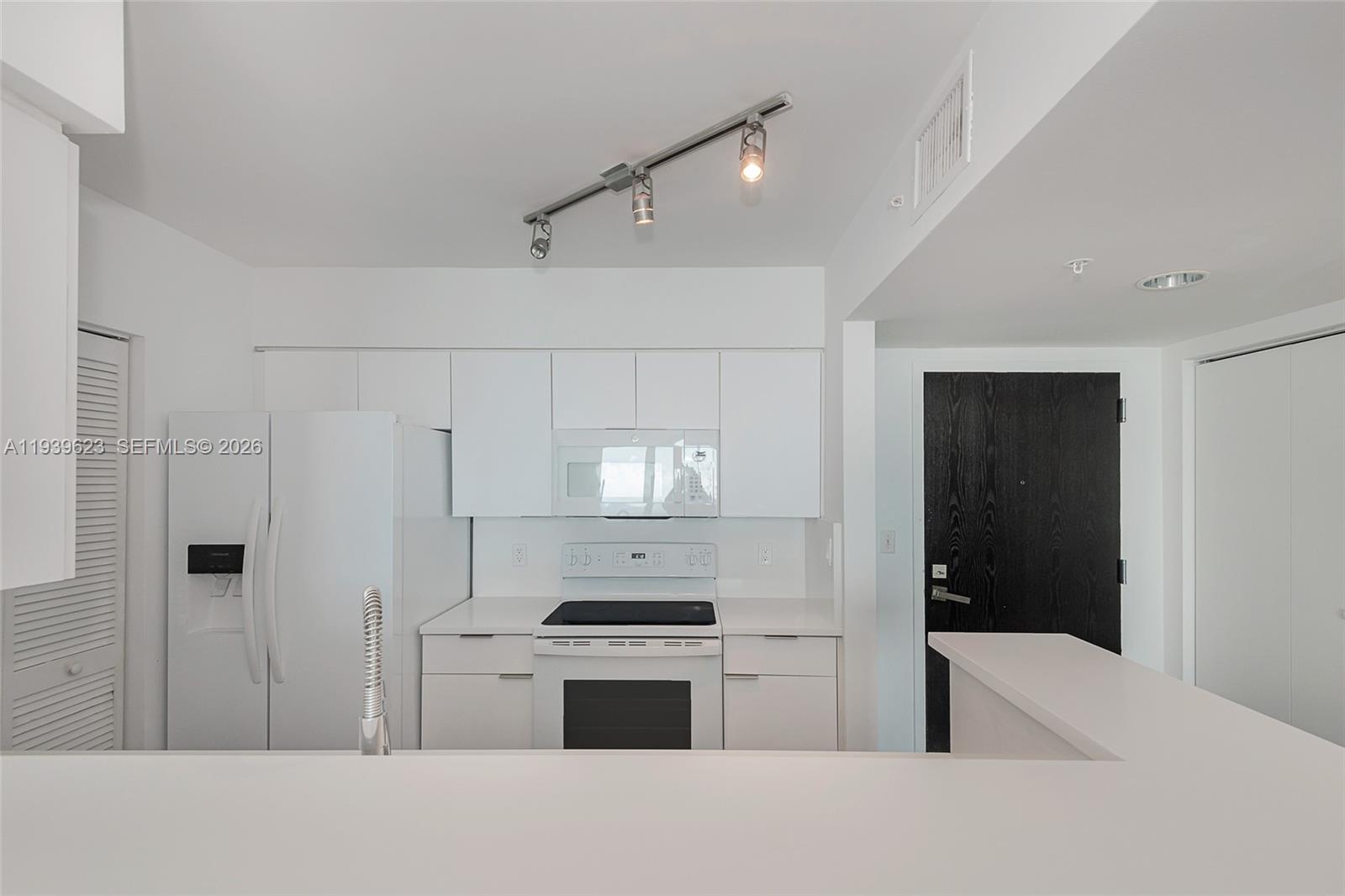 90 Alton Road, Unit 2008 Miami Beach, FL 33139 - Photo 15 of 28 a kitchen with stainless steel appliances a refrigerator and a stove