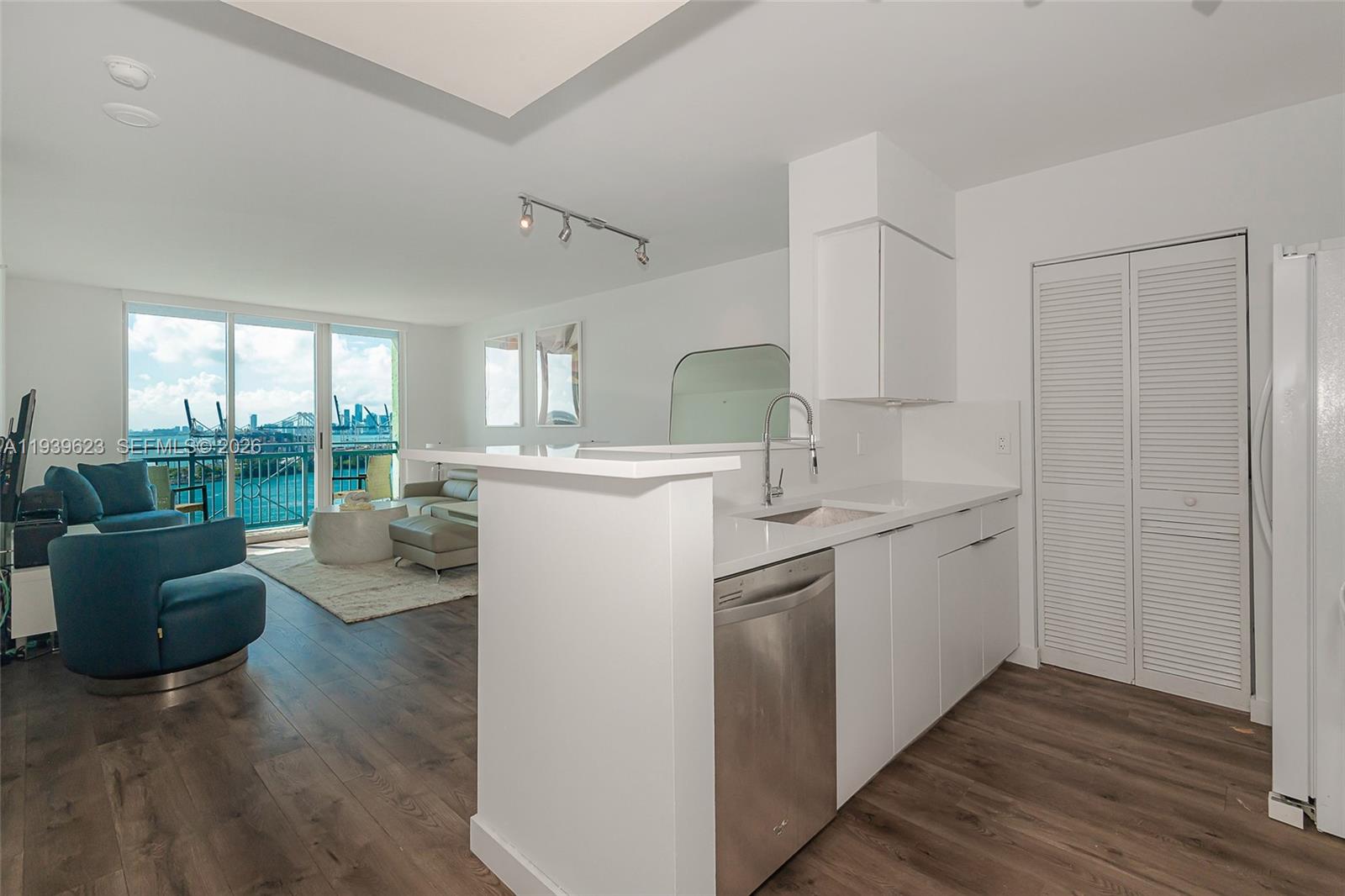 90 Alton Road, Unit 2008 Miami Beach, FL 33139 - Photo 17 of 28 a kitchen with a sink and living room
