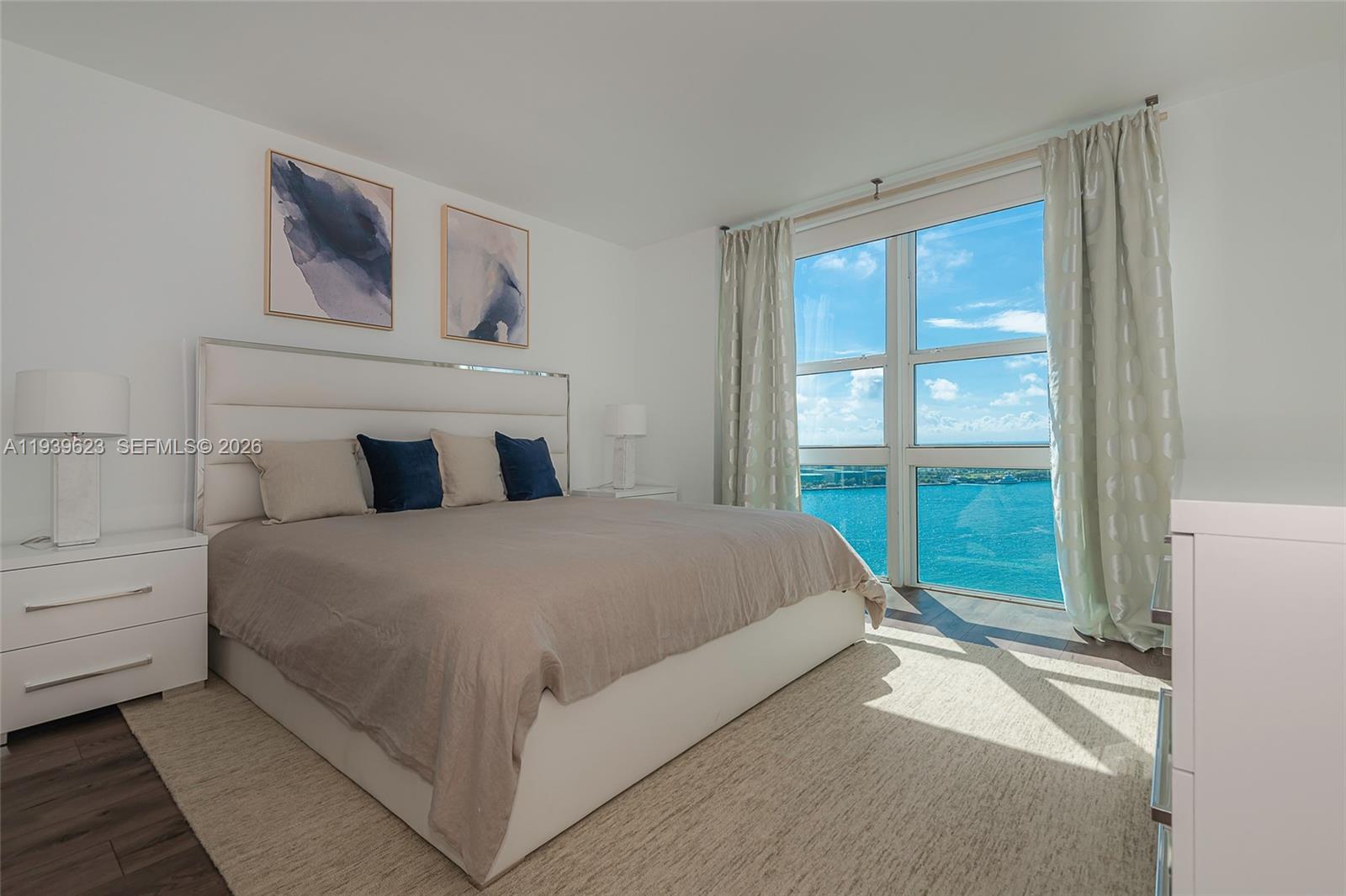90 Alton Road, Unit 2008 Miami Beach, FL 33139 - Photo 19 of 28 a bedroom with a large bed and a window