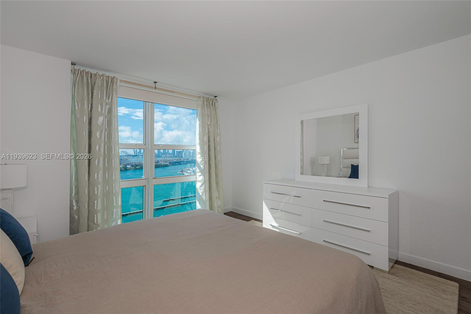 90 Alton Road, Unit 2008 Miami Beach, FL 33139 - Photo 20 of 28 a bedroom with a bed and a window