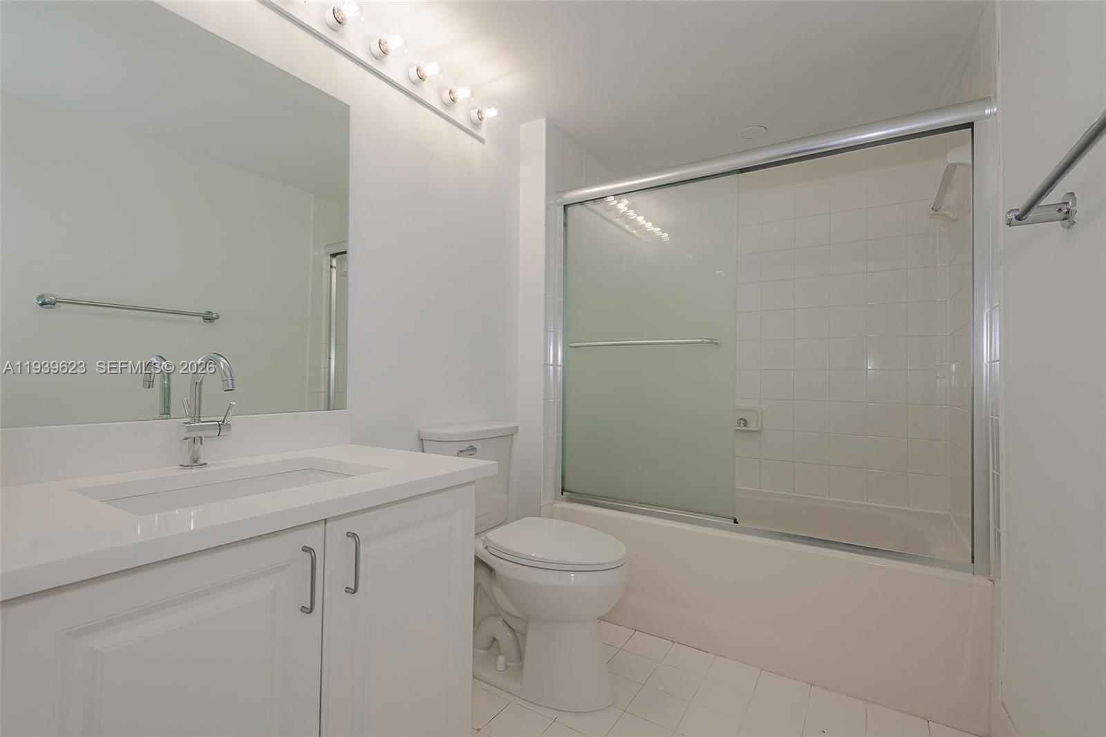 90 Alton Road, Unit 2008 Miami Beach, FL 33139 - Photo 24 of 28 a bathroom with a sink toilet vanity and shower