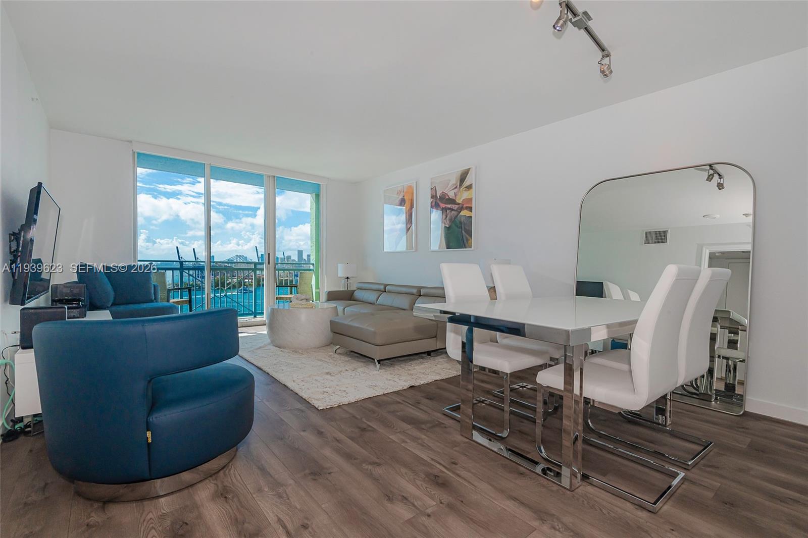 90 Alton Road, Unit 2008 Miami Beach, FL 33139 - Photo 6 of 28 a living room with furniture and a window