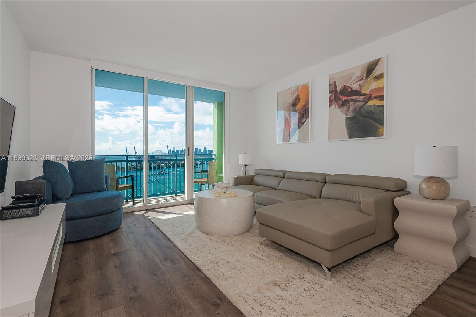 90 Alton Road, Unit 2008 Miami Beach, FL 33139 - Photo 7 of 28 a living room with furniture and a large window