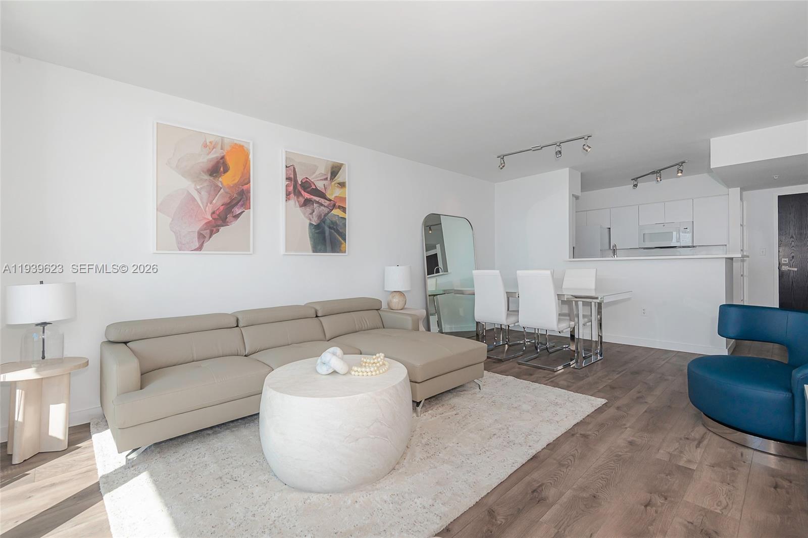 90 Alton Road, Unit 2008 Miami Beach, FL 33139 - Photo 9 of 28 a living room with furniture and a table