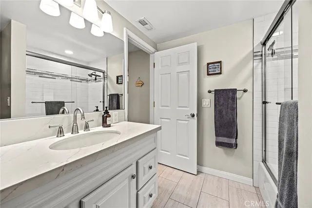 a bathroom with a sink a mirror and a shower