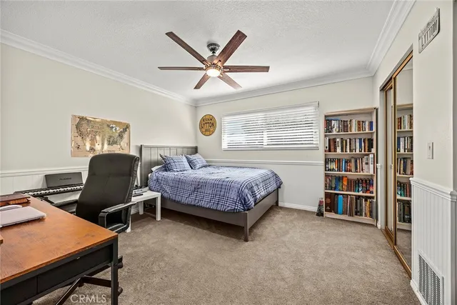 a bedroom with a bed and a bookshelf