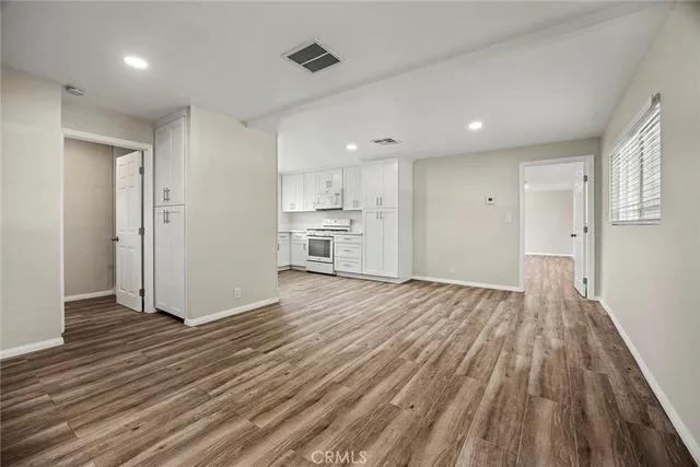 a view of a kitchen with wooden floor and a sink