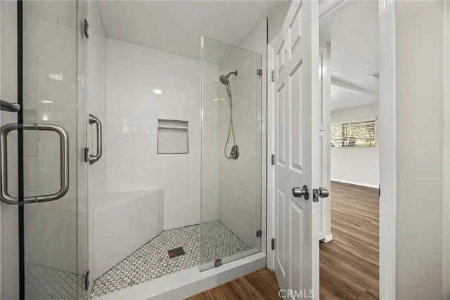 a bathroom with a shower and a sink