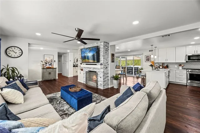 a living room with furniture kitchen view and a fireplace