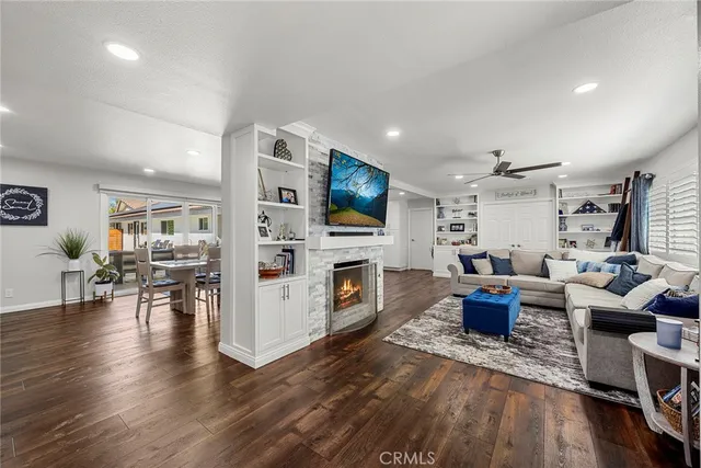a living room with fireplace furniture and a flat screen tv