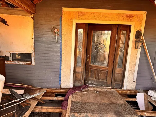 a living room with furniture and stairs
