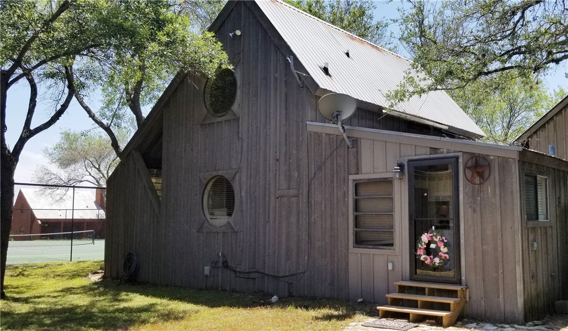 128 Topspin Circle Spicewood, TX 78669 - Photo 1 of 1 a backyard of a house with barbeque oven and outdoor seating
