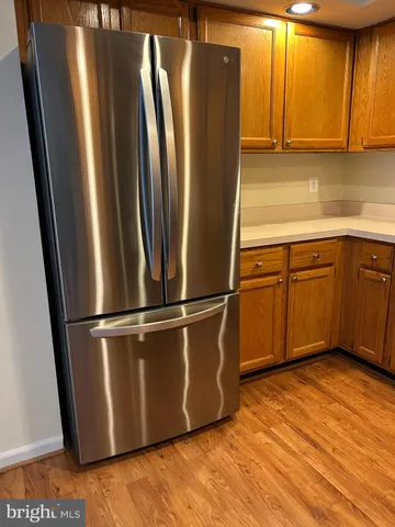 a kitchen with stainless steel appliances granite countertop a refrigerator sink and cabinets