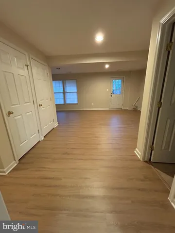 a view of a room with an empty space and wooden floor