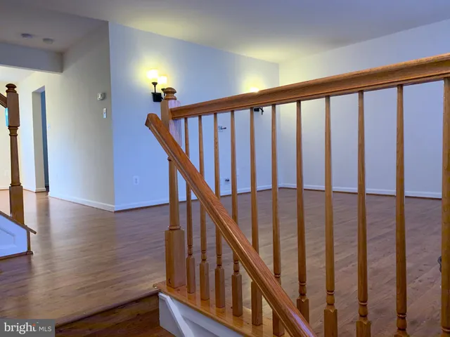 a view of staircase with wooden floor and stairs