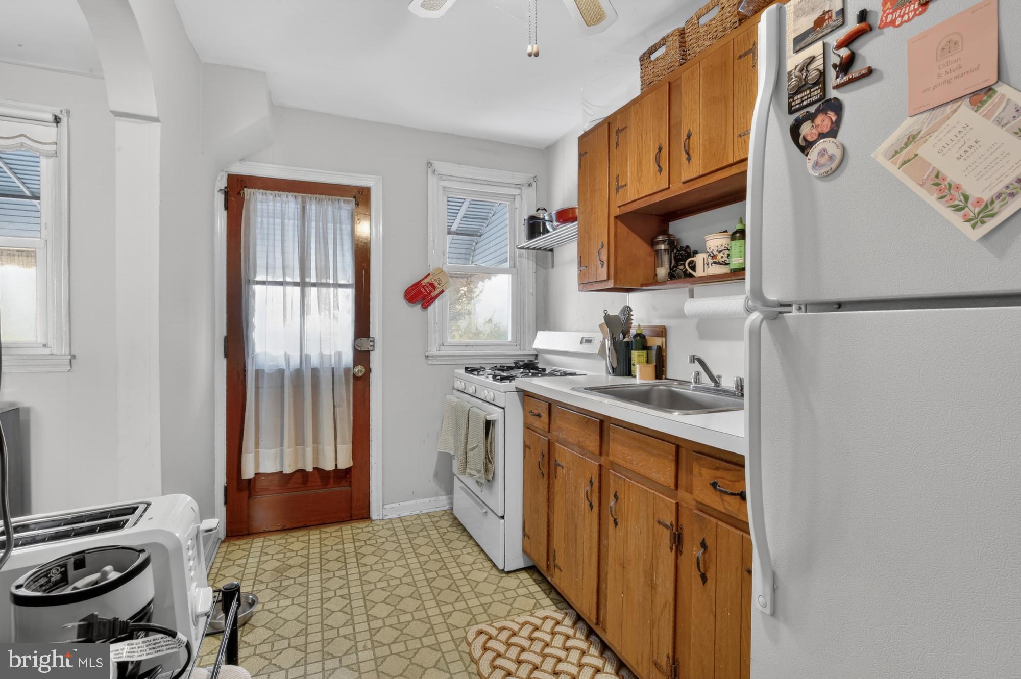 3048 Miller Street Philadelphia, PA 19134 - Photo 10 of 22 a kitchen with a refrigerator and a stove top oven