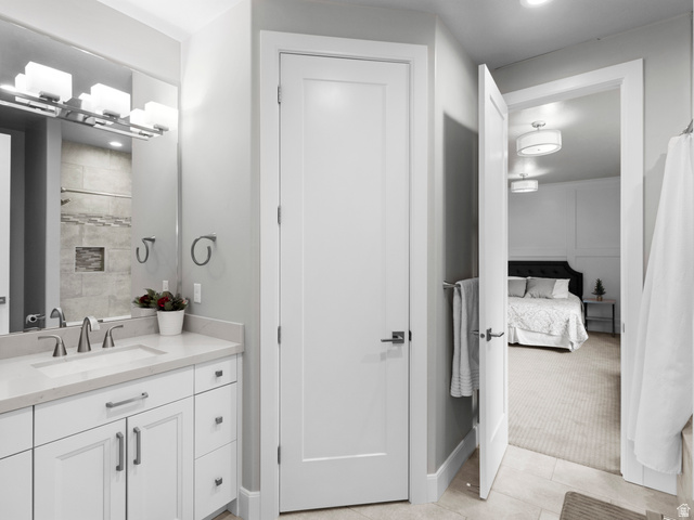 614 East High Lane Alpine, UT 84004 - Photo 65 of 75 Ensuite bathroom with curtained shower, vanity, light tile patterned flooring, recessed lighting, and light colored carpet