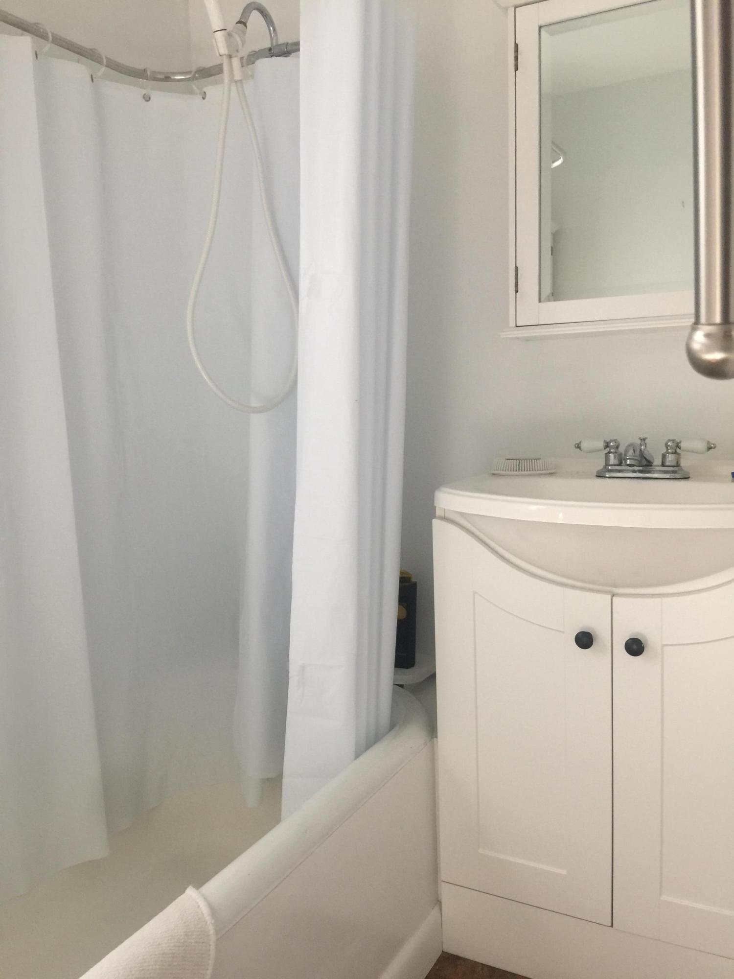 77 Brick Kiln Road Falmouth, MA 02536 - Photo 7 of 10 a bathroom with a sink a mirror and a shower