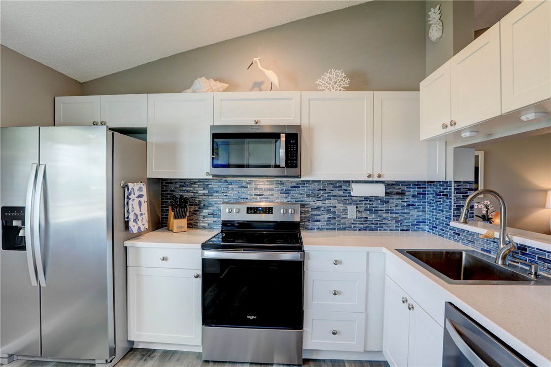 a kitchen with a sink a stove and refrigerator