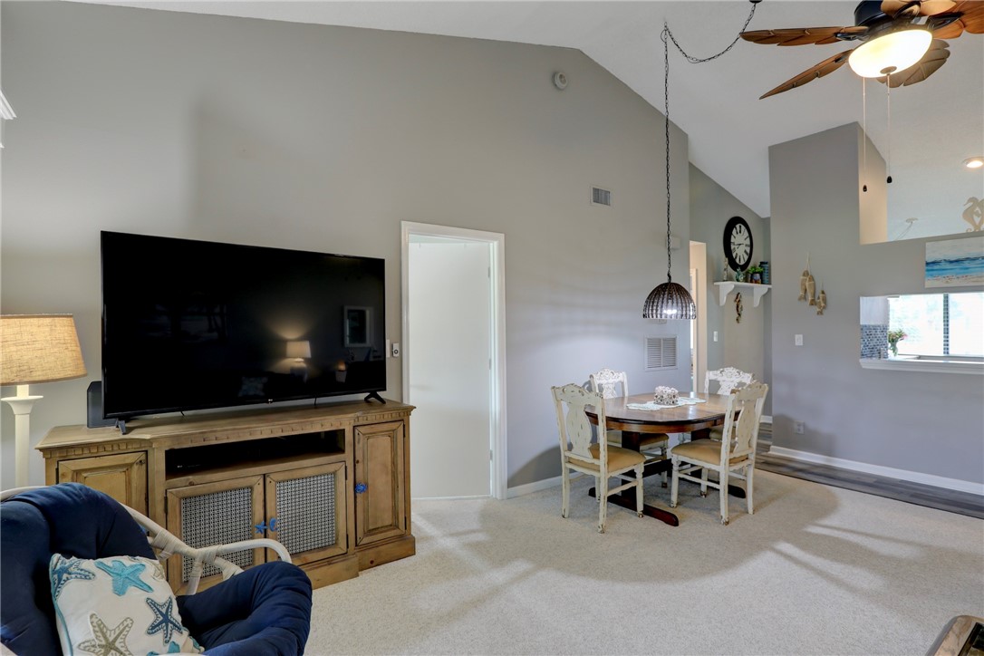 5725 Pelican Pointe Drive, Unit 4 Sebastian, FL 32958 - Photo 12 of 36 a living room with furniture and a flat screen tv