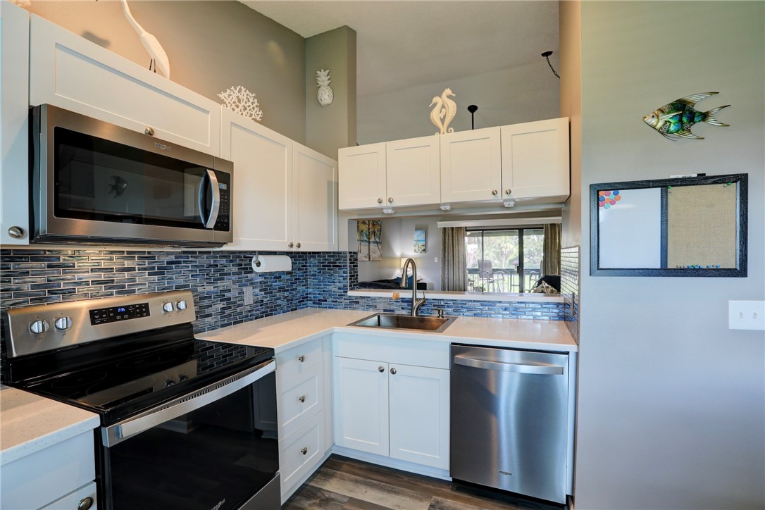 5725 Pelican Pointe Drive, Unit 4 Sebastian, FL 32958 - Photo 17 of 36 a kitchen with a stove microwave and sink