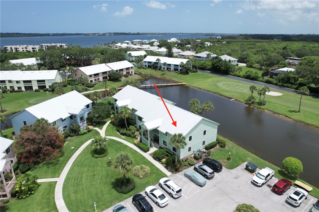 5725 Pelican Pointe Drive, Unit 4 Sebastian, FL 32958 - Photo 2 of 36 an aerial view of a house with a garden and lake view