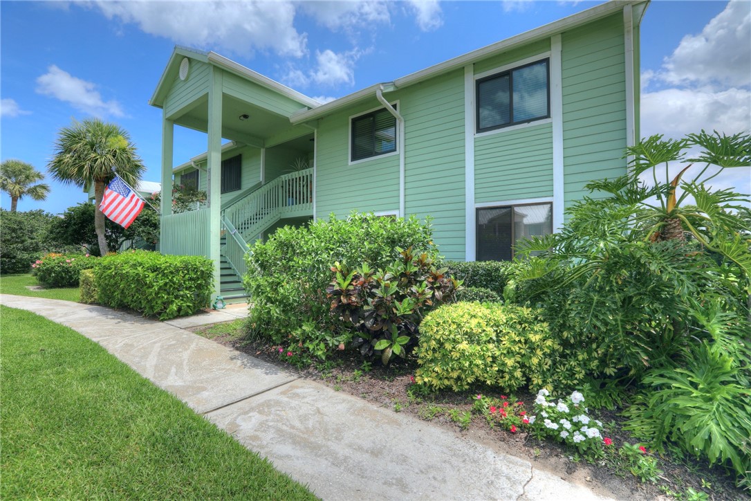 5725 Pelican Pointe Drive, Unit 4 Sebastian, FL 32958 - Photo 5 of 36 a view of a house with potted plants