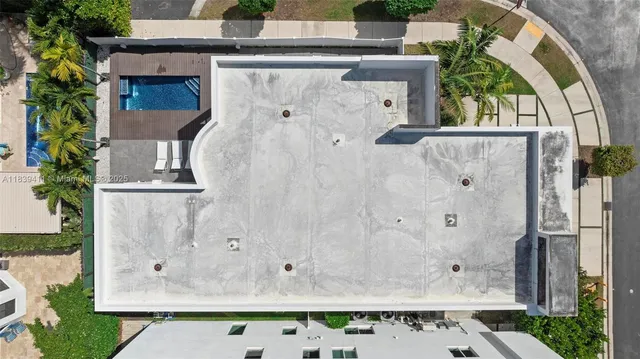 a view of a house with a yard and potted plants